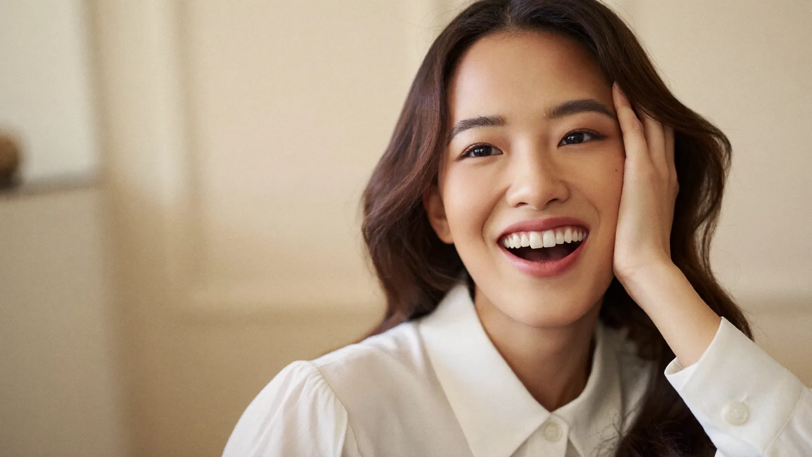 A young Singaporean woman smiling confidently with healthy white teeth
